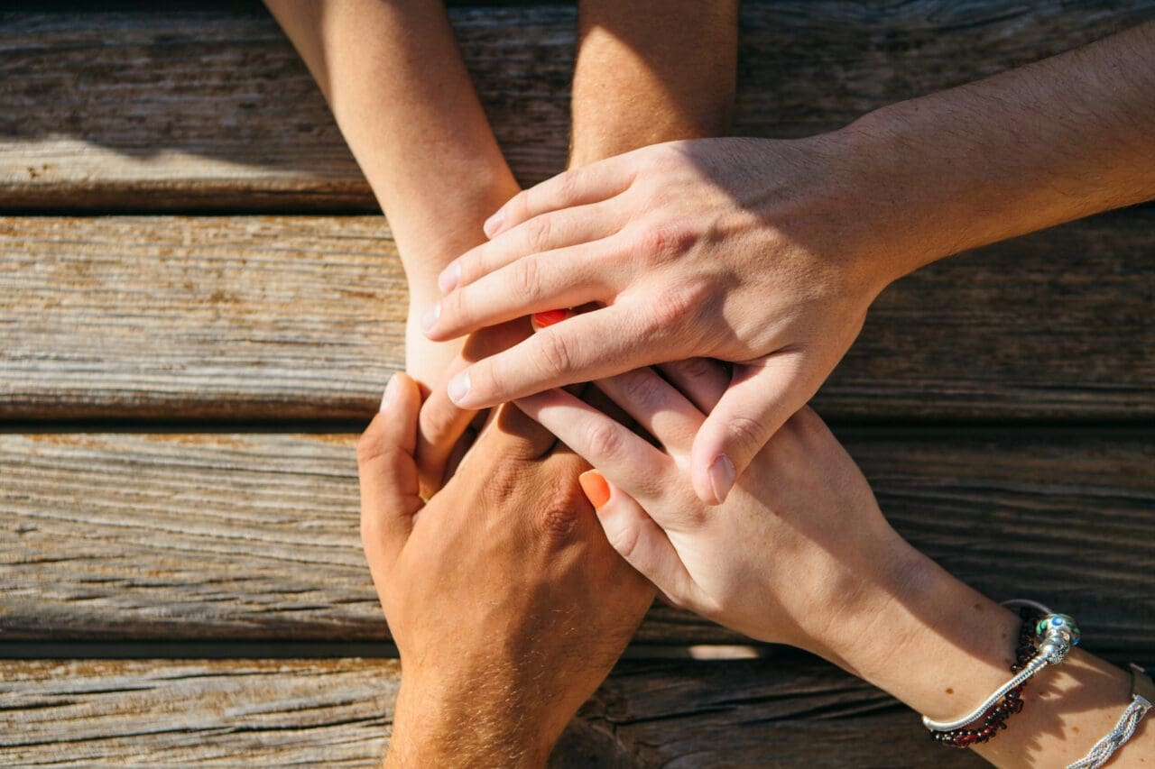 Crop shot of people stacking hands